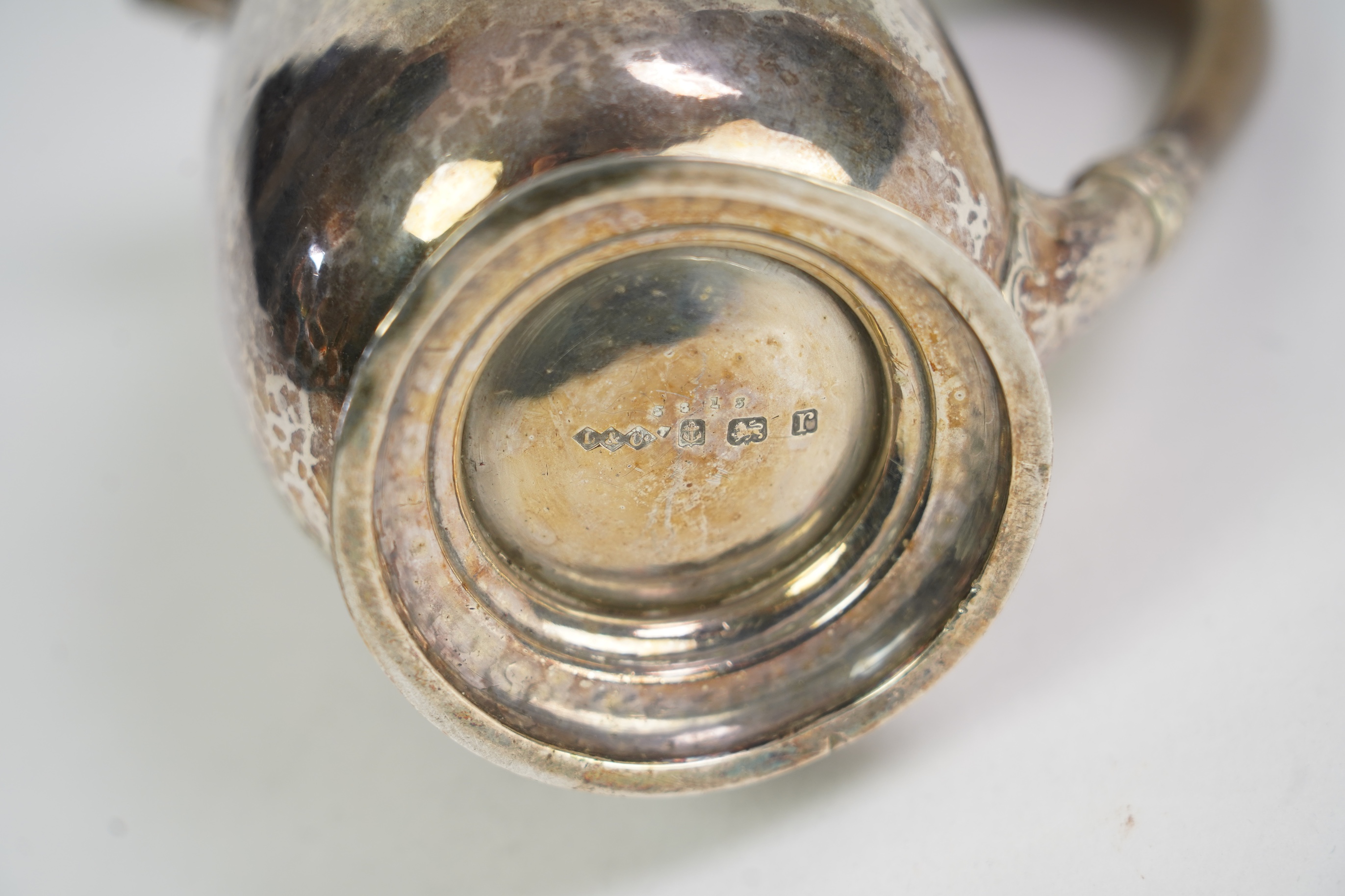 A George V Arts & Crafts silver hot water pot by Liberty & Co